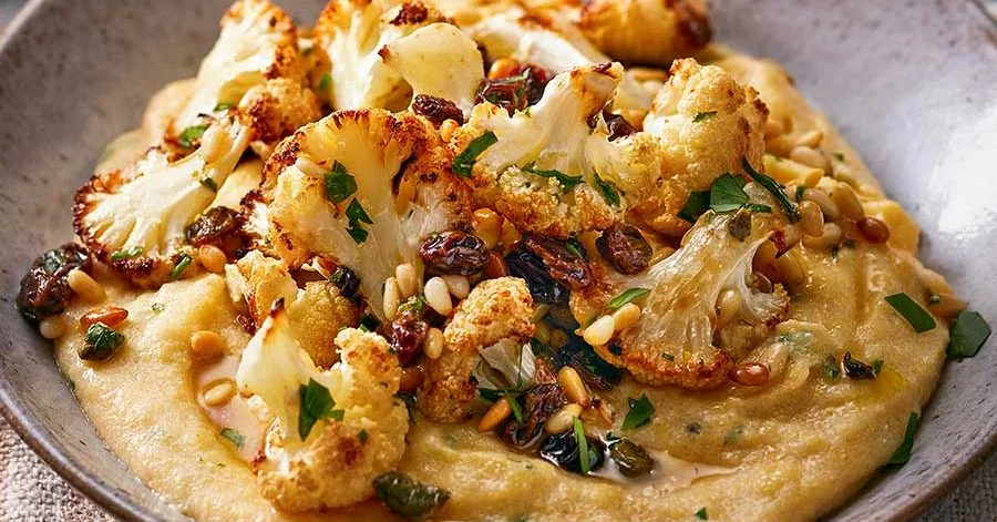 Lemony polenta with roasted cauliflower, pine nuts, raisins & capers