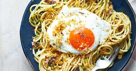 Spaghetti with smoked anchovies, chilli breadcrumbs & fried egg