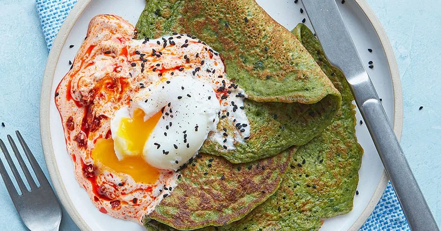 Spinach pancakes with harissa yogurt & poached eggs